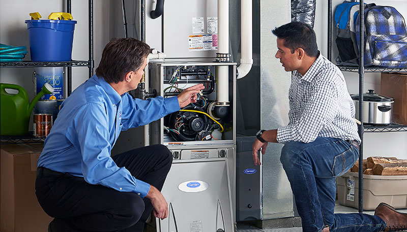 HVAC technician evaluating a furnace for repair or replacement in Phoenix