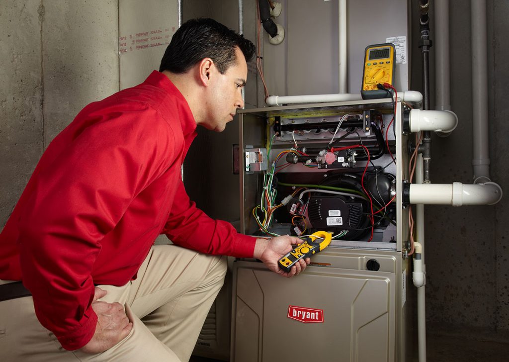 HVAC technician repairing an indoor furnace in Phoenix