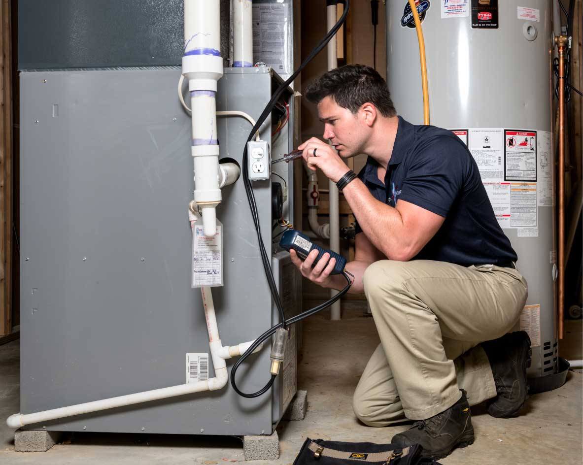 HVAC technician performing a furnace tune-up in Phoenix