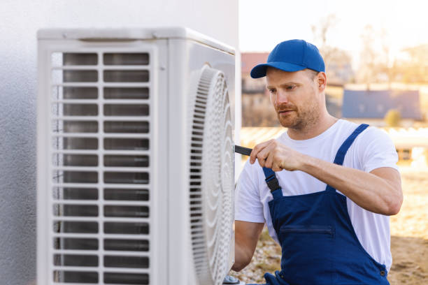 HVAC technician servicing an outdoor air conditioning unit in Phoenix