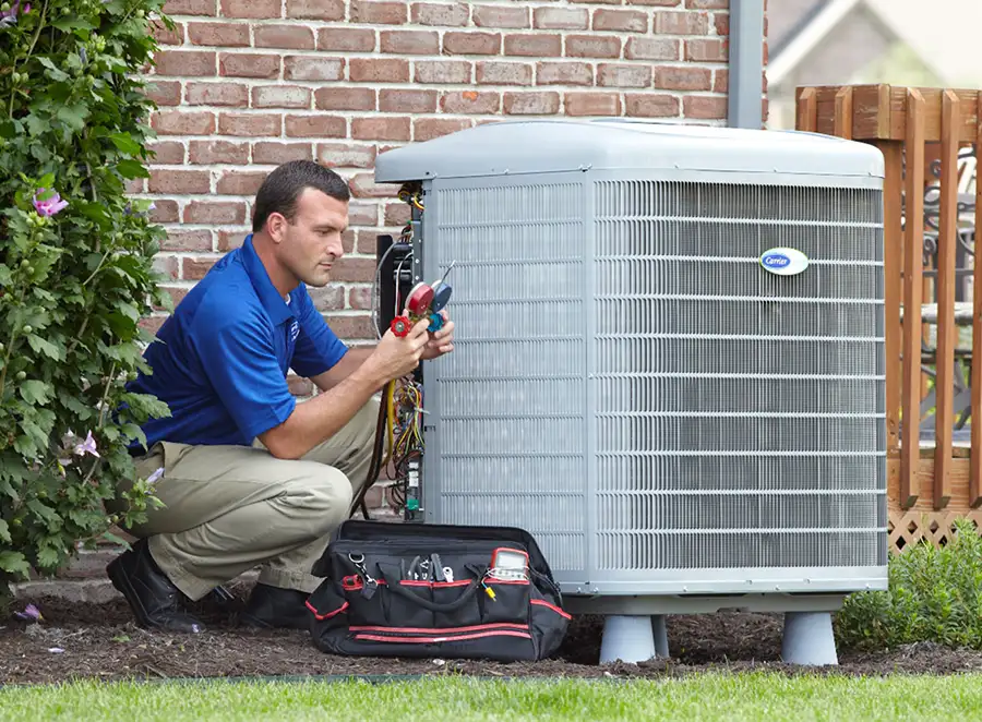 HVAC technician inspecting an outdoor air conditioning unit in Phoenix