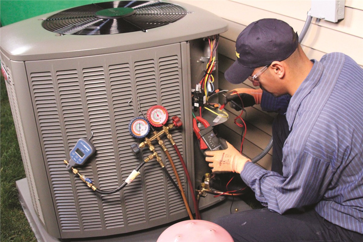 HVAC technician testing an outdoor air conditioning unit in Phoenix